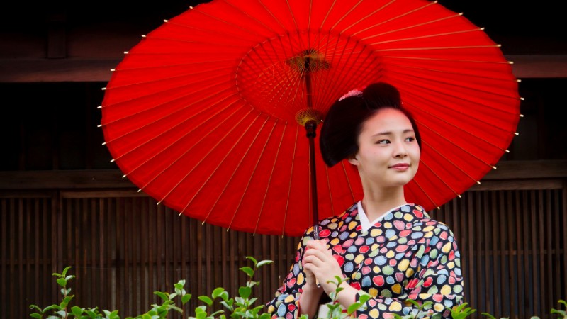 A woman in traditional Japanese attire holding a red parasol, showcasing cultural elegance., tags: japanse te - pexel